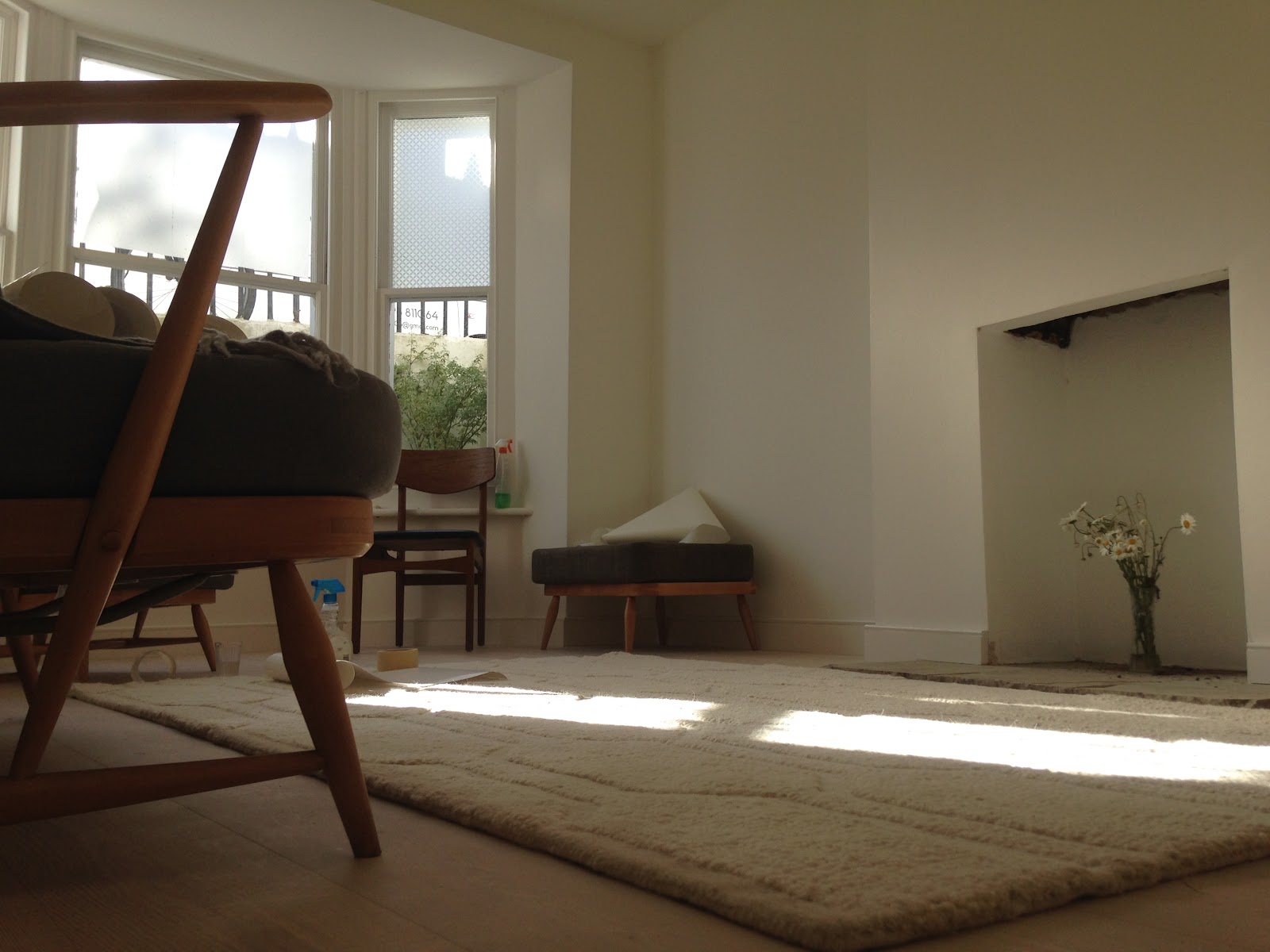 Finished, light-filled renovated living room with restored fireplace recess